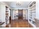 Hallway features stylish barn door leading to a combined laundry and bathroom with built-in shelving at , Social Circle, GA 30025