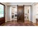 Combined laundry and bathroom with stylish barn door access, patterned floors, and modern appliances at , Social Circle, GA 30025