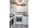 Well-organized laundry area with modern washer and dryer, stylish patterned floor and plenty of cabinet space at , Social Circle, GA 30025