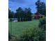 Secluded outdoor area with a stock tank pool and a charming structure in a well-maintained backyard at , Social Circle, GA 30025