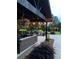 Charming outdoor patio with comfortable seating, stone accents, hanging plants, and string lights at , Social Circle, GA 30025