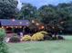 Relaxing outdoor setting showcasing a stone fireplace, comfortable seating, and ambient string lighting at , Social Circle, GA 30025