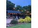 Inviting outdoor space featuring a stone fireplace, a built-in bar, and comfortable seating around a fire pit at , Social Circle, GA 30025