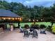 Outdoor patio features a built-in stone bar, comfortable seating around a fire pit, and soft ambient lighting at , Social Circle, GA 30025