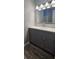 Updated bathroom vanity features gray cabinetry, white countertop, and modern lighting fixture above mirror at 1194 Clichy Ct, Marietta, GA 30066