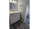 Modern bathroom with updated vanity, mirror, and dark hardwood floors at 1194 Clichy Ct, Marietta, GA 30066