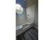Bright bathroom with a large tub, tile surround, and a unique octagonal window at 1194 Clichy Ct, Marietta, GA 30066