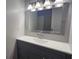Bathroom boasts a modern vanity with a white countertop and an updated framed mirror at 1194 Clichy Ct, Marietta, GA 30066