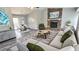 Open-concept living room with stone fireplace, modern furniture, and hardwood-style flooring at 1194 Clichy Ct, Marietta, GA 30066