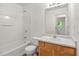 Bathroom with a tub-shower combo, oak vanity, and framed mirror providing a functional space at 2736 Parkway Trl, Lithonia, GA 30058