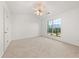 Bright, carpeted bedroom featuring a ceiling fan and a scenic outside view at 2736 Parkway Trl, Lithonia, GA 30058