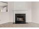 Fireplace with dark hearth and mantle, and view of the kitchen at 2736 Parkway Trl, Lithonia, GA 30058