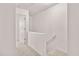 Hallway with carpeted floor, a wooden handrail, and freshly painted walls at 2736 Parkway Trl, Lithonia, GA 30058