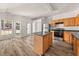 Functional kitchen boasts a central island, wood cabinets, stainless appliances, and access to the backyard at 2736 Parkway Trl, Lithonia, GA 30058