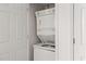All-white stacked washer and dryer unit providing in-home laundry solutions at 2736 Parkway Trl, Lithonia, GA 30058