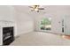Bright living room featuring neutral carpet, fireplace, large window, and fresh paint at 2736 Parkway Trl, Lithonia, GA 30058