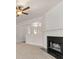 Cozy living room featuring plush carpet, a classic fireplace, and ample natural light at 2736 Parkway Trl, Lithonia, GA 30058