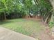 Large backyard with established trees, partial fencing, and mature grass at 3226 Hope St, Hapeville, GA 30354