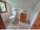 Small attic bathroom with tiled floors, a window, toilet, and vanity sink at 3226 Hope St, Hapeville, GA 30354