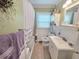 Charming bathroom featuring a shower-tub, a vanity sink, and a classic wainscot at 3226 Hope St, Hapeville, GA 30354