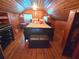 Attic bedroom with wood paneling, hardwood floors, and a queen bed with side tables at 3226 Hope St, Hapeville, GA 30354