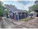 View of the home's exterior showcasing the fenced yard and driveway at 3226 Hope St, Hapeville, GA 30354