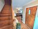 Inviting foyer with hardwood flooring, a wooden staircase, and a charming front door at 3226 Hope St, Hapeville, GA 30354