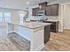 Kitchen featuring granite countertops, stainless steel appliances and large island with sink at 3305 Morgan Rd, Buford, GA 30519