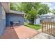 Cozy backyard patio with brick pavers, outdoor seating, and a detached garage at 588 Angier Ne Ave, Atlanta, GA 30308