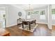 Elegant dining room with hardwood floors, a modern chandelier, and large windows at 588 Angier Ne Ave, Atlanta, GA 30308