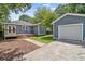 Exterior view of home with detached garage, deck, patio, and green lawn at 588 Angier Ne Ave, Atlanta, GA 30308