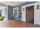 Close-up of the front porch with a charming craftsman-style door and an outdoor seating area at 588 Angier Ne Ave, Atlanta, GA 30308