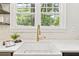 Close-up of the kitchen sink area, highlighting the modern fixtures and stylish backsplash at 588 Angier Ne Ave, Atlanta, GA 30308