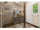 Modern bathroom with a glass shower, pebble flooring, tiled walls, and a recessed shower niche at 588 Angier Ne Ave, Atlanta, GA 30308
