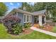 Landscaped side exterior with a well-maintained lawn, mature bushes, and a walkway to the covered porch at 588 Angier Ne Ave, Atlanta, GA 30308