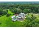 Aerial view of the home, garage, pool, and expansive, lush, green property at 2595 Ross Rd, Snellville, GA 30039