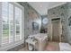 Floral bathroom featuring a garden tub, shower stall, round window, and classic design at 2595 Ross Rd, Snellville, GA 30039