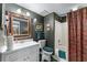 Classic bathroom with patterned walls, a framed mirror, and a shower/tub combo at 2595 Ross Rd, Snellville, GA 30039