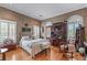 Charming bedroom with hardwood floors, plantation shutters, and an eclectic collection of decor and furniture at 2595 Ross Rd, Snellville, GA 30039