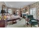 Bedroom with a fireplace, floral wallpaper, four poster bed, and arched windows at 2595 Ross Rd, Snellville, GA 30039