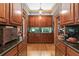 Well-appointed butler's pantry showcasing custom cabinetry, stone countertops, and wood flooring at 2595 Ross Rd, Snellville, GA 30039