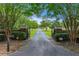 An impressive gated entrance and a long driveway lead up to this sprawling estate property at 2595 Ross Rd, Snellville, GA 30039