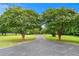 Long, private driveway lined with mature trees and landscaping leading to the home at 2595 Ross Rd, Snellville, GA 30039