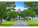 A long paved driveway leads up to this grand home that features a cupola, attached garage and meticulously kept grounds at 2595 Ross Rd, Snellville, GA 30039