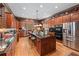 Spacious kitchen boasts wood cabinets, granite countertops, stainless steel appliances, and a kitchen island at 2595 Ross Rd, Snellville, GA 30039