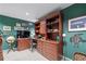 Stylish home office features built-in shelving, unique artwork, and a classic writing desk at 2595 Ross Rd, Snellville, GA 30039