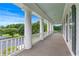 View of the expansive front porch featuring white columns and wood decking at 2595 Ross Rd, Snellville, GA 30039