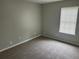 Neutral bedroom offers plush carpeting, a window, and ample natural light at 3951 Mcgill Dr, Decatur, GA 30034