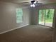 Bright bedroom featuring neutral walls, carpet flooring, ceiling fan and access to the outdoors through sliding glass doors at 3951 Mcgill Dr, Decatur, GA 30034