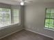 This cozy bedroom offers three bright windows that enhance the room's natural lighting and features neutral paint and carpet at 3951 Mcgill Dr, Decatur, GA 30034